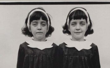 Visages de deux jumelles identiques en serre-tête et col blanc, détail d’une photographie de Diane Arbus (Roselle, 1967)